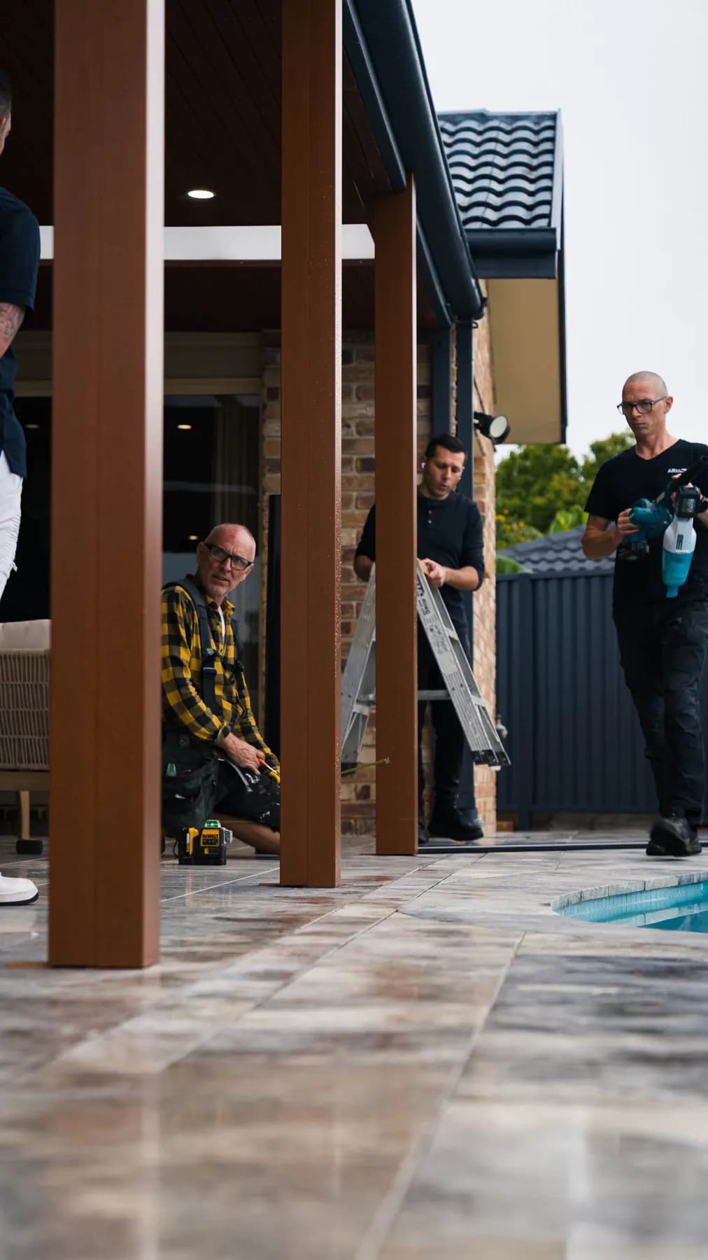 Flo Glass Fence installers working beside a pool